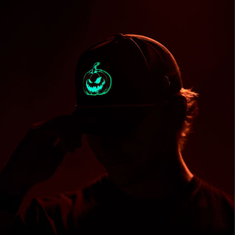 Jack-O-Lantern Glow Flat Trucker  Black, Charcoal, Heather Gray, Navy